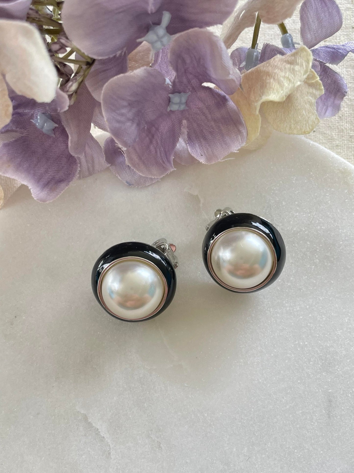 Large imitation pearl with black surround clip-on earrings