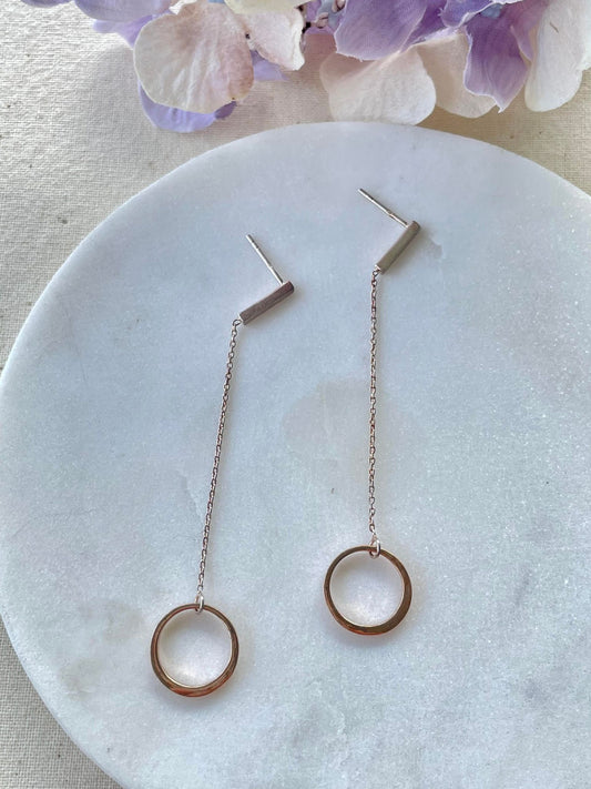 Sterling silver rose gold circle set on a long fine chain stud earring