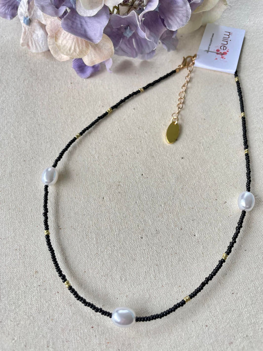 Black choker highlighted with pearls