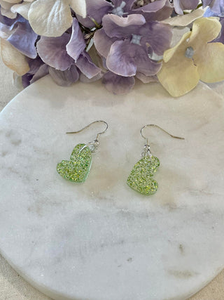 Off center lime green glitter heart earrings