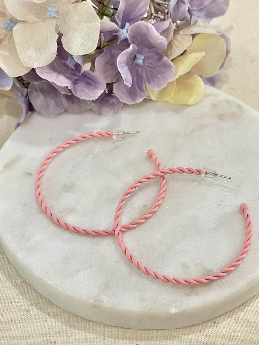 Large light pink knotted hoops