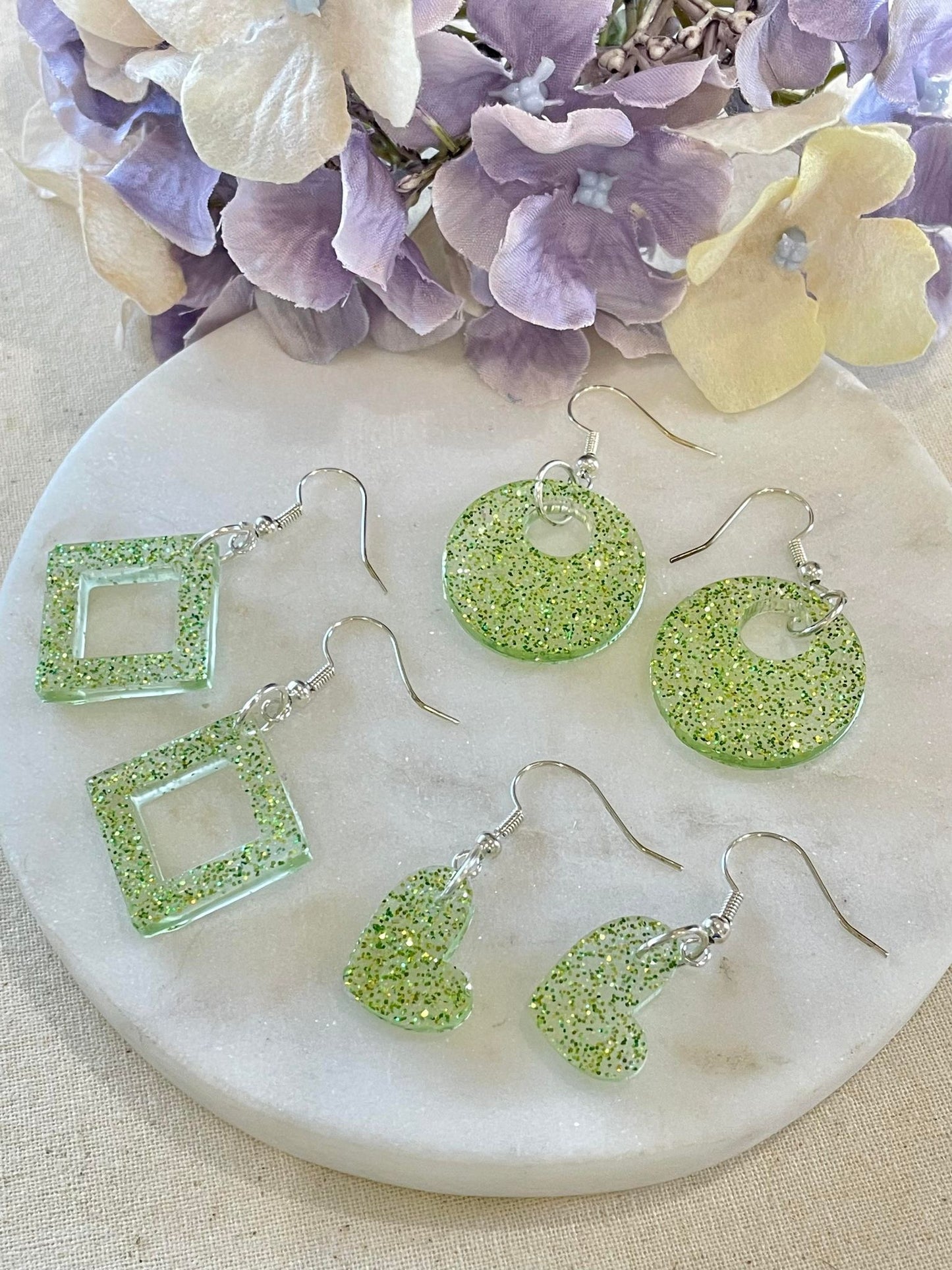Off center lime green glitter heart earrings