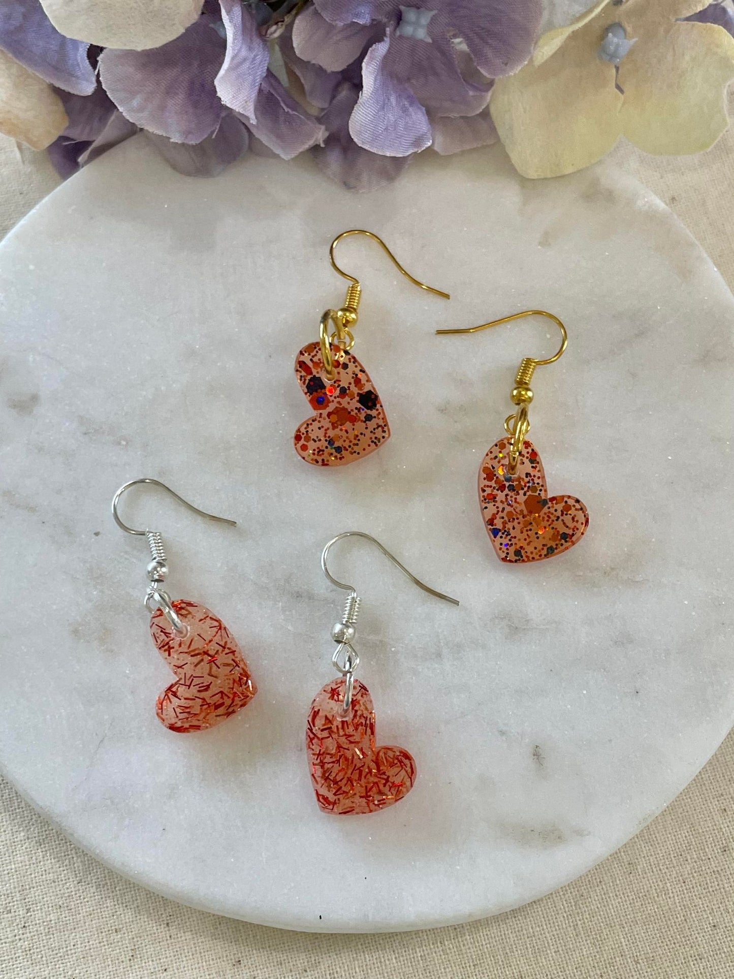 Clear hearts with red glitter off center heart drop earrings